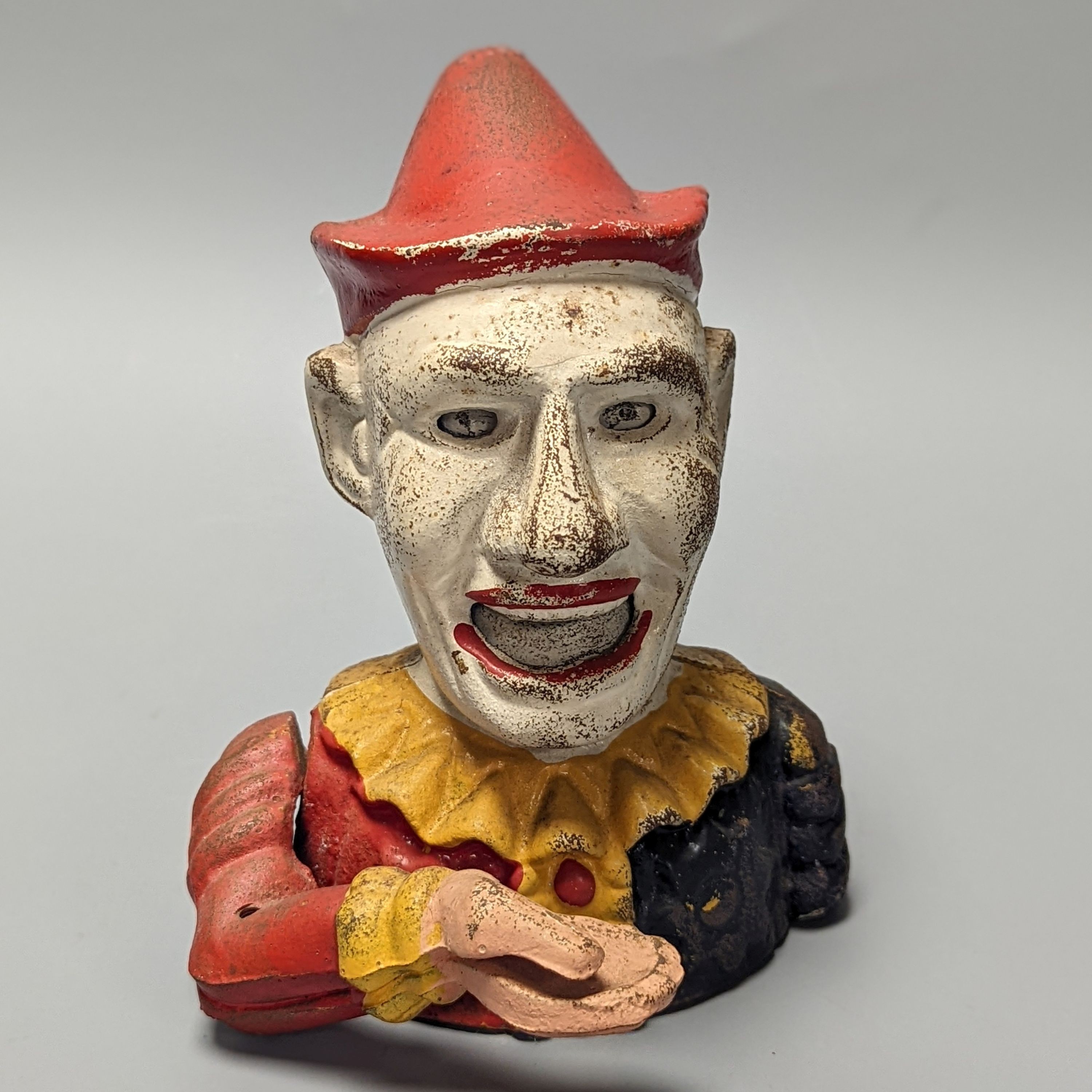 A cold painted cast iron ‘jester’ money bank 17cm